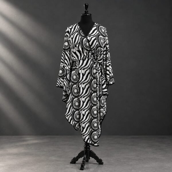 SELLBAY Signature Boho Kaftan in a black and white artistic print, displayed on a mannequin with flowing asymmetrical design, wide sleeves, V-neckline, black border finishing, and adjustable inner belt.