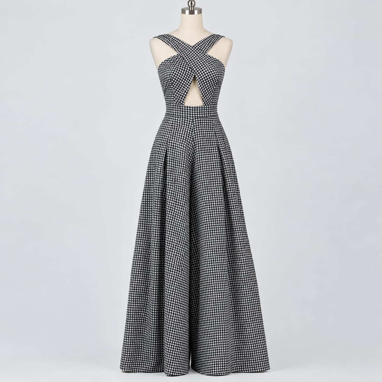 Black and white gingham cross-back palazzo jumpsuit with crossover bodice and wide-leg trousers displayed on a mannequin