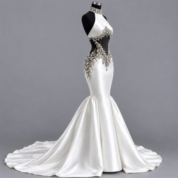 Side view of an ivory silk mermaid bridal gown showing the fitted silhouette, crystal embellishment and flowing train