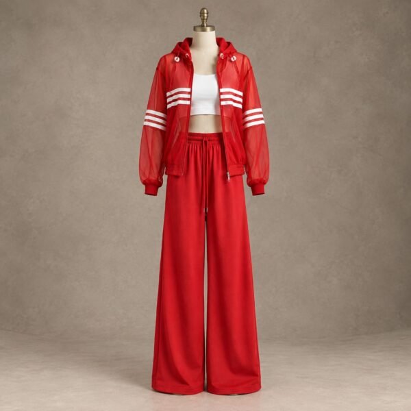 Red women's two-piece tracksuit with sheer hooded zip-up jacket, white stripe detailing, matching wide-leg track pants and white crop top displayed on a mannequin.