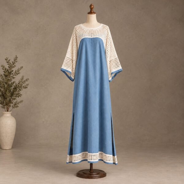 Blue and cream full-length maxi dress with crochet upper panel, wide sleeves, blue trim, and side slits displayed on a mannequin.