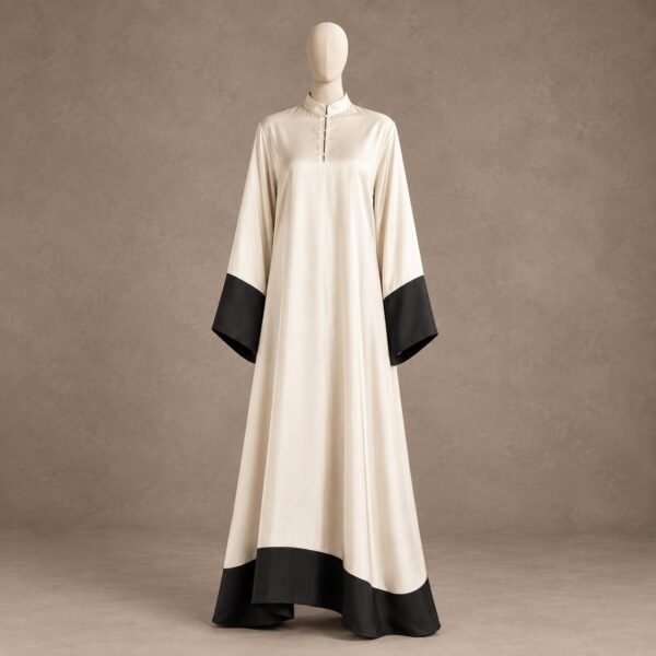 SELLBAY ivory silk abaya with black borders on wide sleeves and hem, stand collar, and full-length loose silhouette displayed on a mannequin.